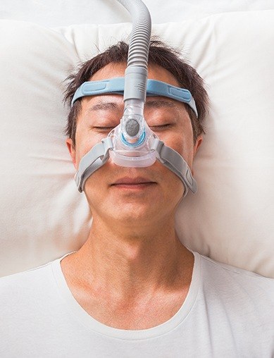 man laying on back with mask on