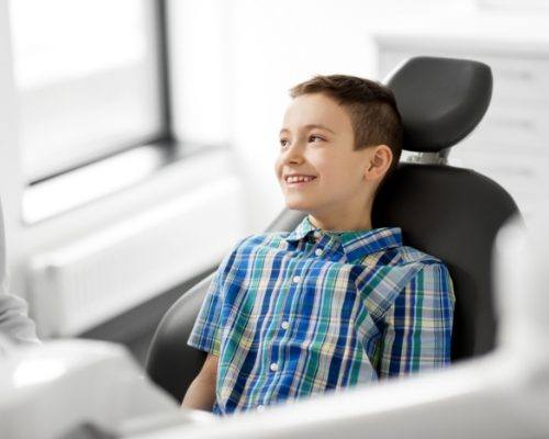 boy smiling in exam chair