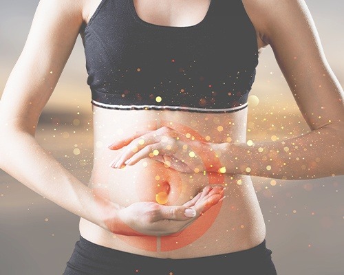 woman holding hands around stomach area