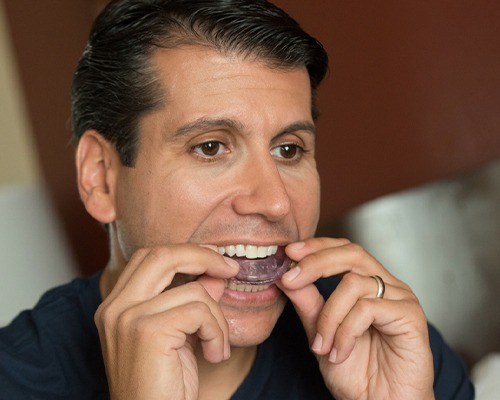 man putting in cpap appliance