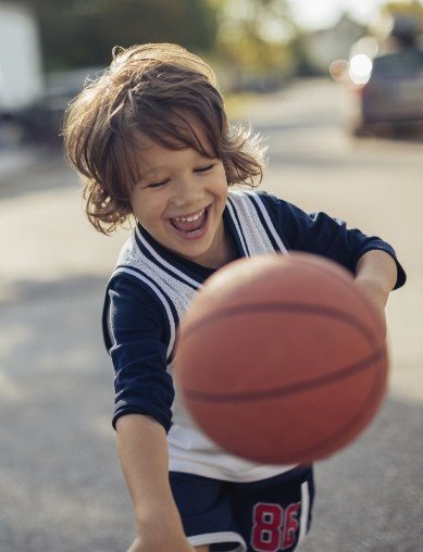 young boy playing basketball
