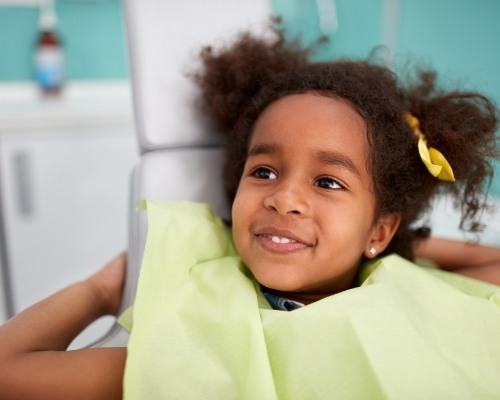 young girl sitting in exam chair