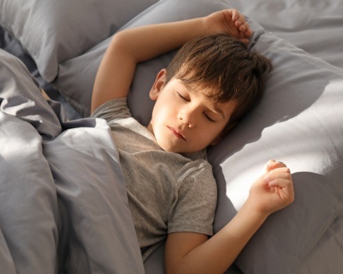 boy sleeping peacefully in bed