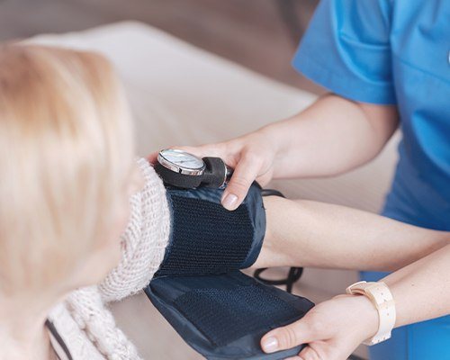 woman having blood pressure taken