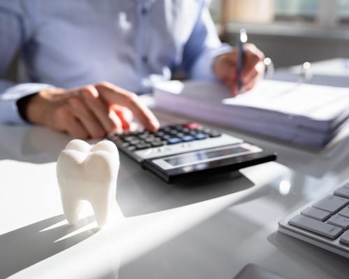 man doing paperwork and using calculator