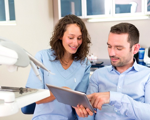 Dentist and patient talking about laser snoring treatment