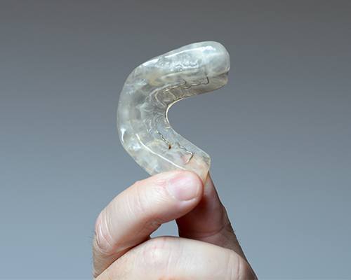 woman holding oral appliance