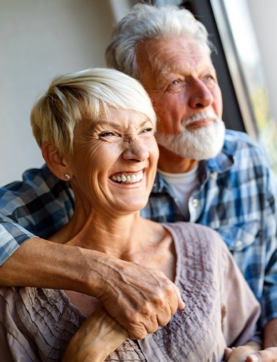 husband and wife hugging and smiling