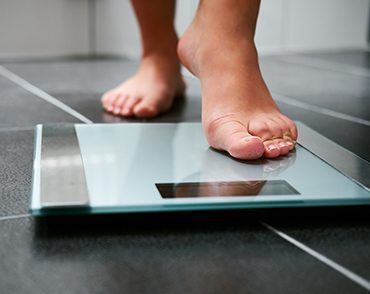 person stepping on scale