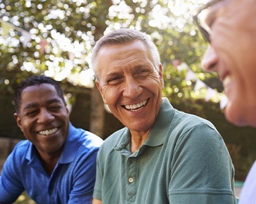 man laughing with friends