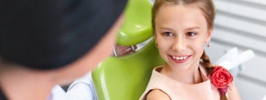 young girl smiling at dentist