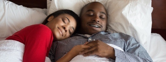 man and woman sleeping comfortably
