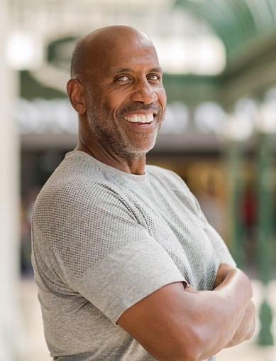 man in grey shirt smiling