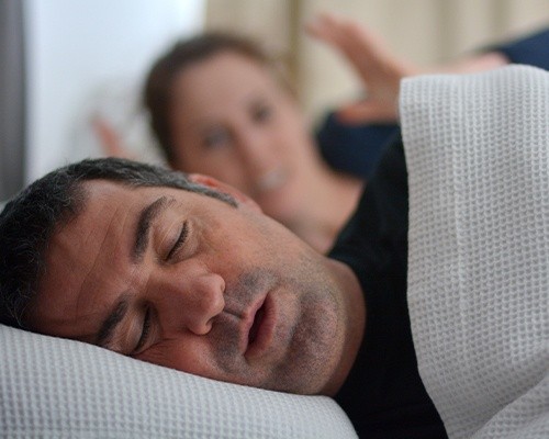 woman frustrated with husband snoring