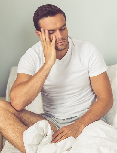 man holding side of face with hand