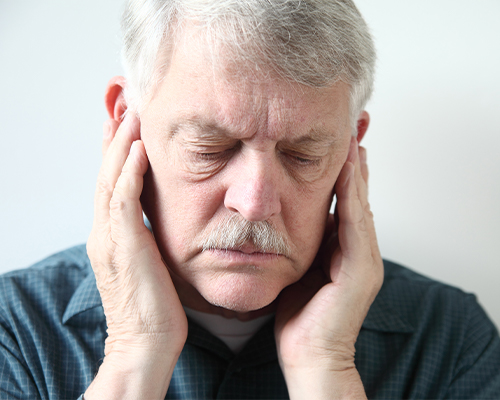 man holding jaw in pain