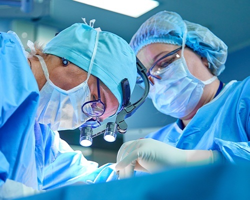 Dentist doing TMJ Prosthetic Joint Replacement