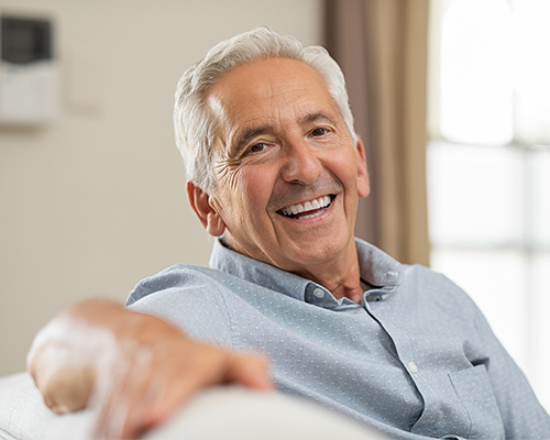 man smiling on camera on couch