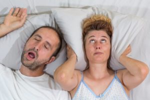 man sleeping snoring woman upset