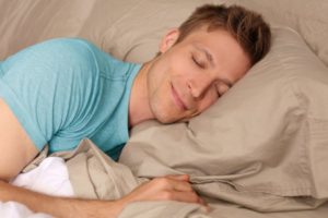 man smiling sleeping peacefully