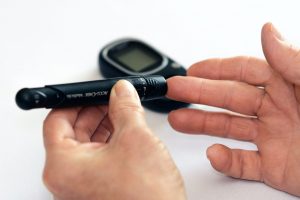 Man with diabetes checking blood sugar