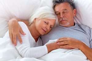 Couple sleeping peacefully after successful laser snoring treatment