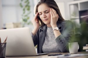 Exhausted woman sitting at computer