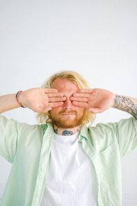 Man covering eyes with hands