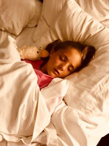 Young girl sleeping in bed