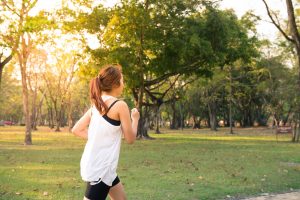 Woman running through park