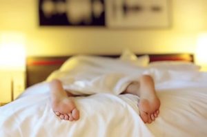 Person’s feet sleeping in bed