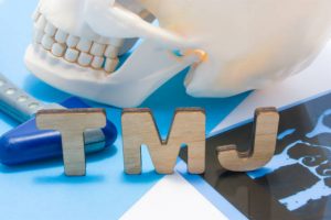 Skull and wooden letters spelling TMJ