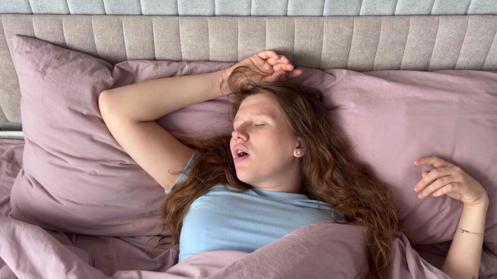 Woman sleeping in a bed